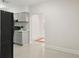 Bright kitchen featuring gray cabinetry, subway tile backsplash, and black appliances at 909 E 15Th Ave, Tampa, FL 33605