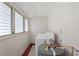 Compact laundry room with washer, water heater, and louvered glass windows at 909 E 15Th Ave, Tampa, FL 33605