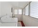 Small laundry room with stacked washer/dryer, natural light, and white walls at 909 E 15Th Ave, Tampa, FL 33605