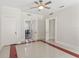 Bright living room featuring light walls, a ceiling fan, and an open doorway to the dining area at 909 E 15Th Ave, Tampa, FL 33605