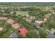 Aerial view of a residential neighborhood with mature trees, lakes, and golf course at 9348 Deer Creek Dr, Tampa, FL 33647