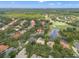 Expansive aerial view of homes near a golf course and pond in a lush, tree-filled community at 9348 Deer Creek Dr, Tampa, FL 33647