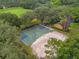 Aerial view of a basketball court, sand volleyball, and a building in a community at 9348 Deer Creek Dr, Tampa, FL 33647