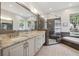 Bright bathroom with double vanity, shower and large mirror at 9348 Deer Creek Dr, Tampa, FL 33647