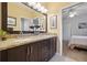 Bathroom with double vanity, granite countertop, and decorative mirrors at 9348 Deer Creek Dr, Tampa, FL 33647