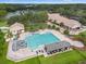 Aerial view of a large community pool with a slide, putt putt, and lounge chairs at 9348 Deer Creek Dr, Tampa, FL 33647