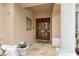 Elegant double front doors with stone flooring and decorative accents at 9348 Deer Creek Dr, Tampa, FL 33647