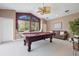 Bright game room with a pool table, a large window and comfortable seating at 9348 Deer Creek Dr, Tampa, FL 33647