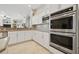 Modern kitchen with stainless steel appliances, backsplash and white cabinets providing elegance at 9348 Deer Creek Dr, Tampa, FL 33647