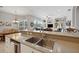 Kitchen sink view showcasing the breakfast nook, open floor plan and view into the living area at 9348 Deer Creek Dr, Tampa, FL 33647