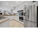 Modern kitchen features stainless steel appliances, island cooktop, and ample cabinet space at 9348 Deer Creek Dr, Tampa, FL 33647