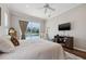 Bedroom featuring a ceiling fan, tv, and an outdoor view at 9348 Deer Creek Dr, Tampa, FL 33647