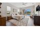 Bright main bedroom with wood floors and view of pool and outdoor space at 9348 Deer Creek Dr, Tampa, FL 33647
