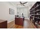 Stylish office with hardwood floors, built-in shelving, and large shuttered windows at 9348 Deer Creek Dr, Tampa, FL 33647