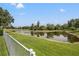 Scenic view of the pond and landscaping from the rear of the property at 9348 Deer Creek Dr, Tampa, FL 33647