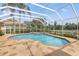 Inviting screened-in pool and patio area with stone flooring perfect for outdoor entertaining at 9348 Deer Creek Dr, Tampa, FL 33647