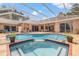 Inviting screened-in pool and patio area featuring a spa and lush landscaping at 9348 Deer Creek Dr, Tampa, FL 33647