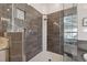 Shower featuring custom tile, and a glass enclosure at 9348 Deer Creek Dr, Tampa, FL 33647