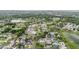 Expansive aerial view showcasing a neighborhood with lush trees, homes, and a tranquil lake at 10110 Pepperidge Ct, Tampa, FL 33615