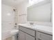 Bathroom featuring grey vanity, white countertops, and a shower-tub combo with white shower walls at 10110 Pepperidge Ct, Tampa, FL 33615