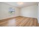 Bright bedroom featuring modern wood-look laminate flooring at 10110 Pepperidge Ct, Tampa, FL 33615
