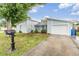 Charming blue single-story home with well-maintained lawn and a pop of color on the front door at 10110 Pepperidge Ct, Tampa, FL 33615