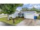 Lovely single-story home featuring a neatly landscaped yard and a bright blue front door at 10110 Pepperidge Ct, Tampa, FL 33615