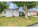 Welcoming single-story home with a blue front door and a well-kept lawn at 10110 Pepperidge Ct, Tampa, FL 33615