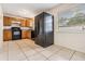 Bright kitchen featuring tile floors, wood cabinets, and modern black appliances at 10110 Pepperidge Ct, Tampa, FL 33615