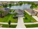 Aerial shot of a home showcasing its well-kept lawn, the nearby pond and proximity to other homes in the neighborhood at 10512 Fuzzy Cattail St, Riverview, FL 33578