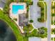 Aerial view of a community pool and clubhouse surrounded by lush landscaping and parking at 10512 Fuzzy Cattail St, Riverview, FL 33578