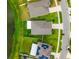 Aerial view of a home showcasing its roof, lawn, and proximity to other homes and pond at 10512 Fuzzy Cattail St, Riverview, FL 33578