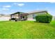 Spacious backyard featuring a well-manicured lawn and a covered patio for outdoor enjoyment at 10512 Fuzzy Cattail St, Riverview, FL 33578