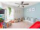 Bright bedroom featuring natural light, soft carpet, a ceiling fan, and play furniture at 10512 Fuzzy Cattail St, Riverview, FL 33578