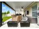 Inviting covered patio with comfortable seating, ceiling fans, and outdoor grilling area at 10512 Fuzzy Cattail St, Riverview, FL 33578