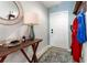 Inviting entryway featuring a table with decor, a decorative mirror and an artistic rug at 10512 Fuzzy Cattail St, Riverview, FL 33578