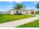 Beautiful home with a well-manicured lawn and a two-car garage is surrounded by nice landscaping at 10512 Fuzzy Cattail St, Riverview, FL 33578