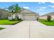 Lovely home with an attached two-car garage, green lawn and well placed landscaping at 10512 Fuzzy Cattail St, Riverview, FL 33578
