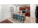 Bright kitchen featuring a large island with barstool seating, stainless appliances and tile flooring at 10512 Fuzzy Cattail St, Riverview, FL 33578