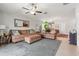Comfortable living room with large sectional sofa, ceiling fan, view to the dining area and kitchen at 10512 Fuzzy Cattail St, Riverview, FL 33578
