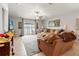 Comfortable living room with large sectional sofa, ceiling fan, TV, and view to the patio at 10512 Fuzzy Cattail St, Riverview, FL 33578
