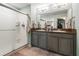 Main bathroom featuring double sink vanity, quartz countertop, large mirror and walk-in shower at 10512 Fuzzy Cattail St, Riverview, FL 33578
