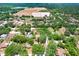 Aerial view of a residential neighborhood, showcasing a house surrounded by lush trees and green spaces at 107 Halton Cir, Seffner, FL 33584