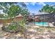 Expansive backyard featuring lush landscaping and a view of the screened-in pool, great for outdoor living at 107 Halton Cir, Seffner, FL 33584
