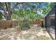 Large backyard with a privacy fence and mature trees, offering a serene outdoor space at 107 Halton Cir, Seffner, FL 33584