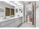 Bright bathroom features a double sink vanity and view to the pool at 107 Halton Cir, Seffner, FL 33584