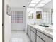 Bright bathroom features a double sink vanity and glass block window for natural light at 107 Halton Cir, Seffner, FL 33584