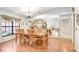 Bright dining room featuring hardwood floors, a decorative light fixture, and a mirrored wall at 107 Halton Cir, Seffner, FL 33584