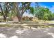 Beautiful single-story residence with mature trees, well-manicured lawn, and a circular driveway, showcasing classic design at 107 Halton Cir, Seffner, FL 33584