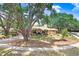 Beautiful single-story home with mature trees and lush landscaping at 107 Halton Cir, Seffner, FL 33584